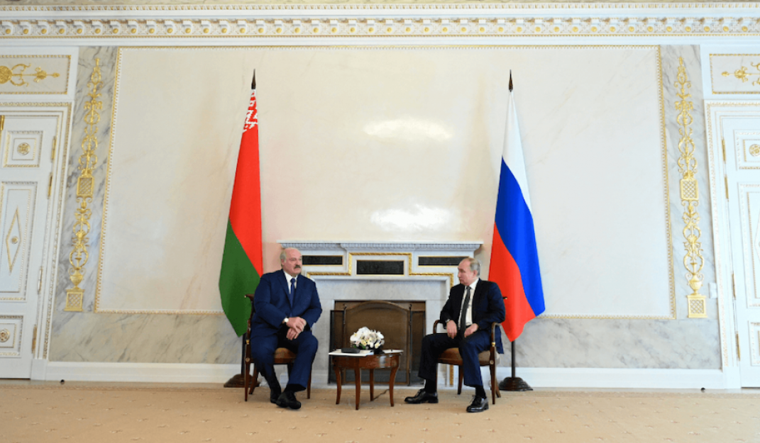 Source: Russian President Vladimir Putin and Belarusian President Alexander Lukashenko talk during a meeting in Saint Petersburg, Russia July 13, 2021. © Reuters