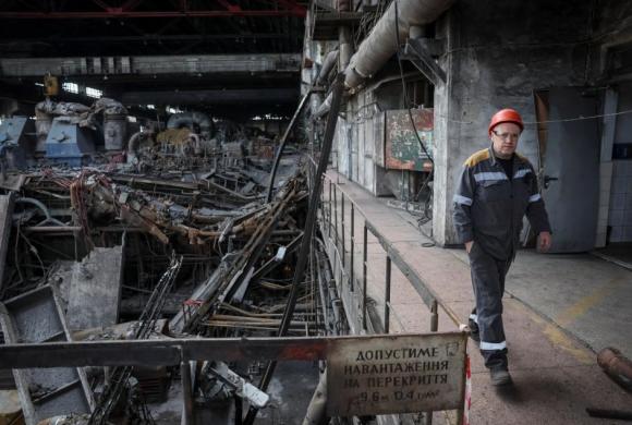 A worker walks at a thermal power plant damaged by recent Russian missile strike, amid Russia's attack on Ukraine, in an undisclosed location of Ukraine April 8, 2024. ©Reuters